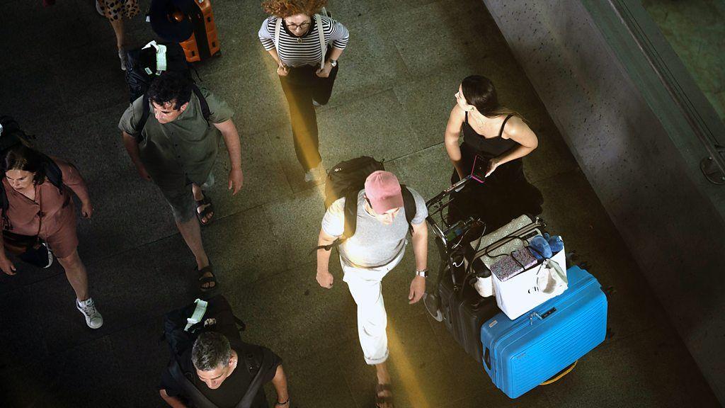 Vista de cima de pessoas carregando bagagem para viajar