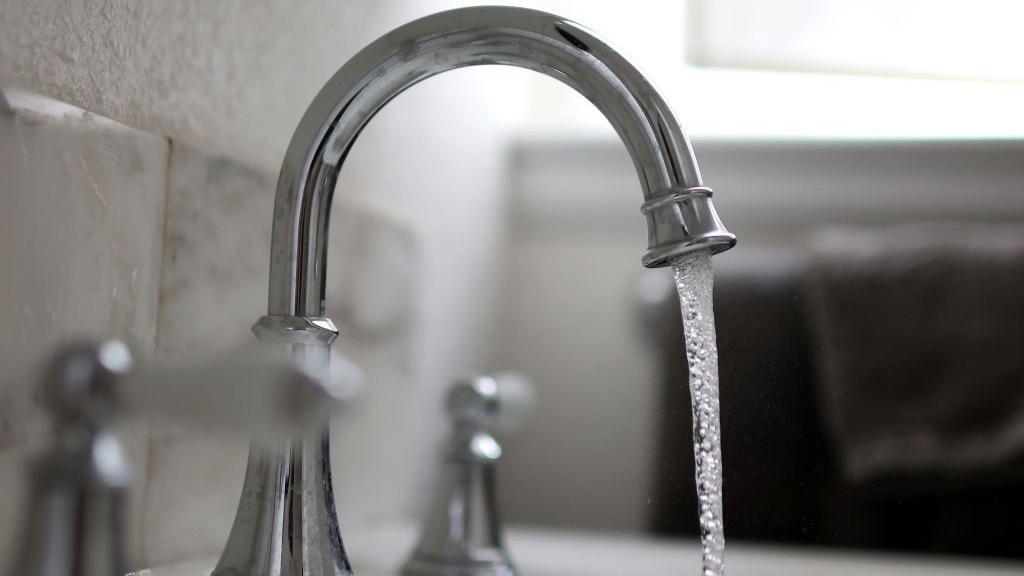 Water falls from a tap