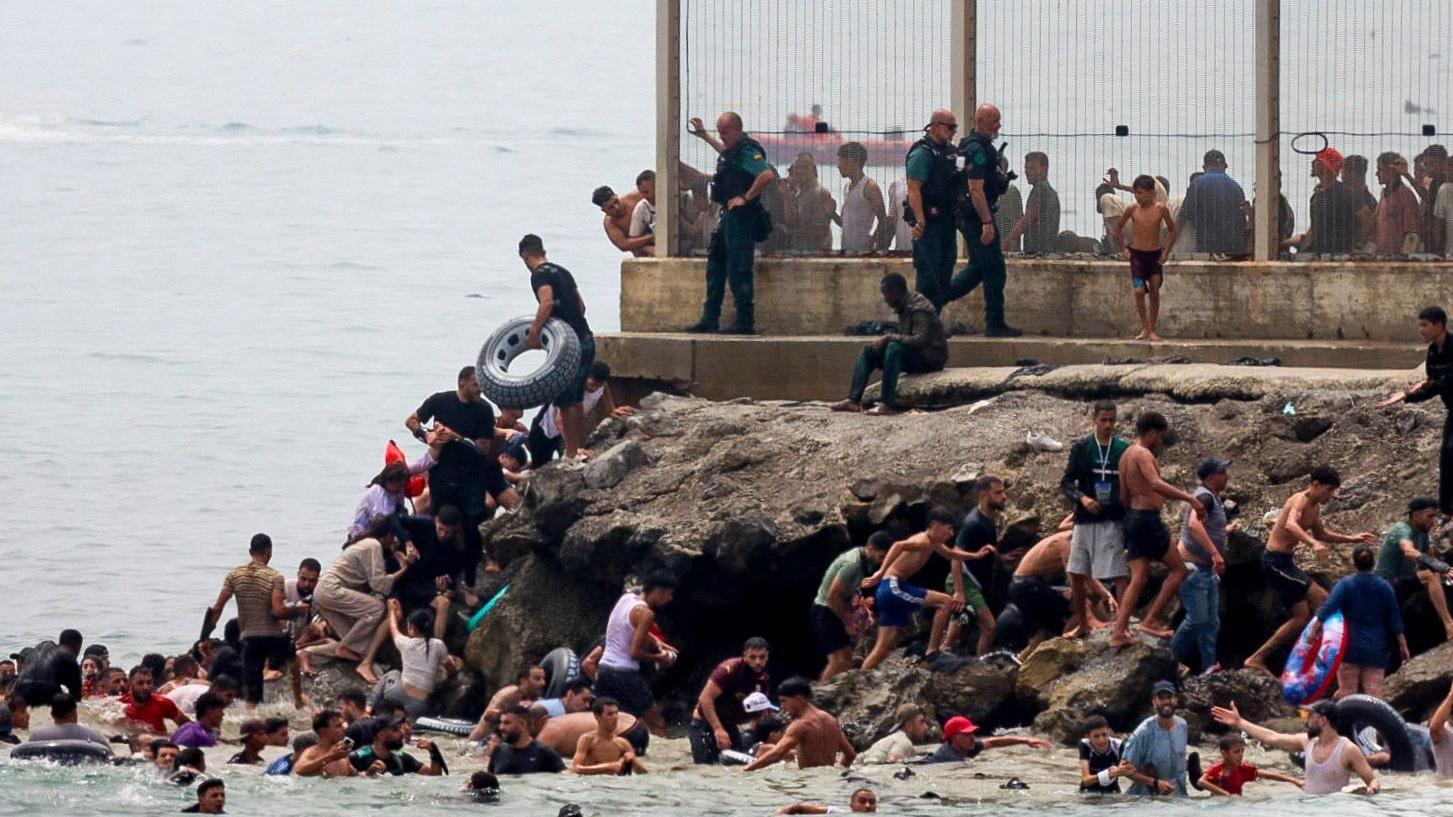 Hundreds of migrants swim from Morocco to Spanish enclave of Ceuta