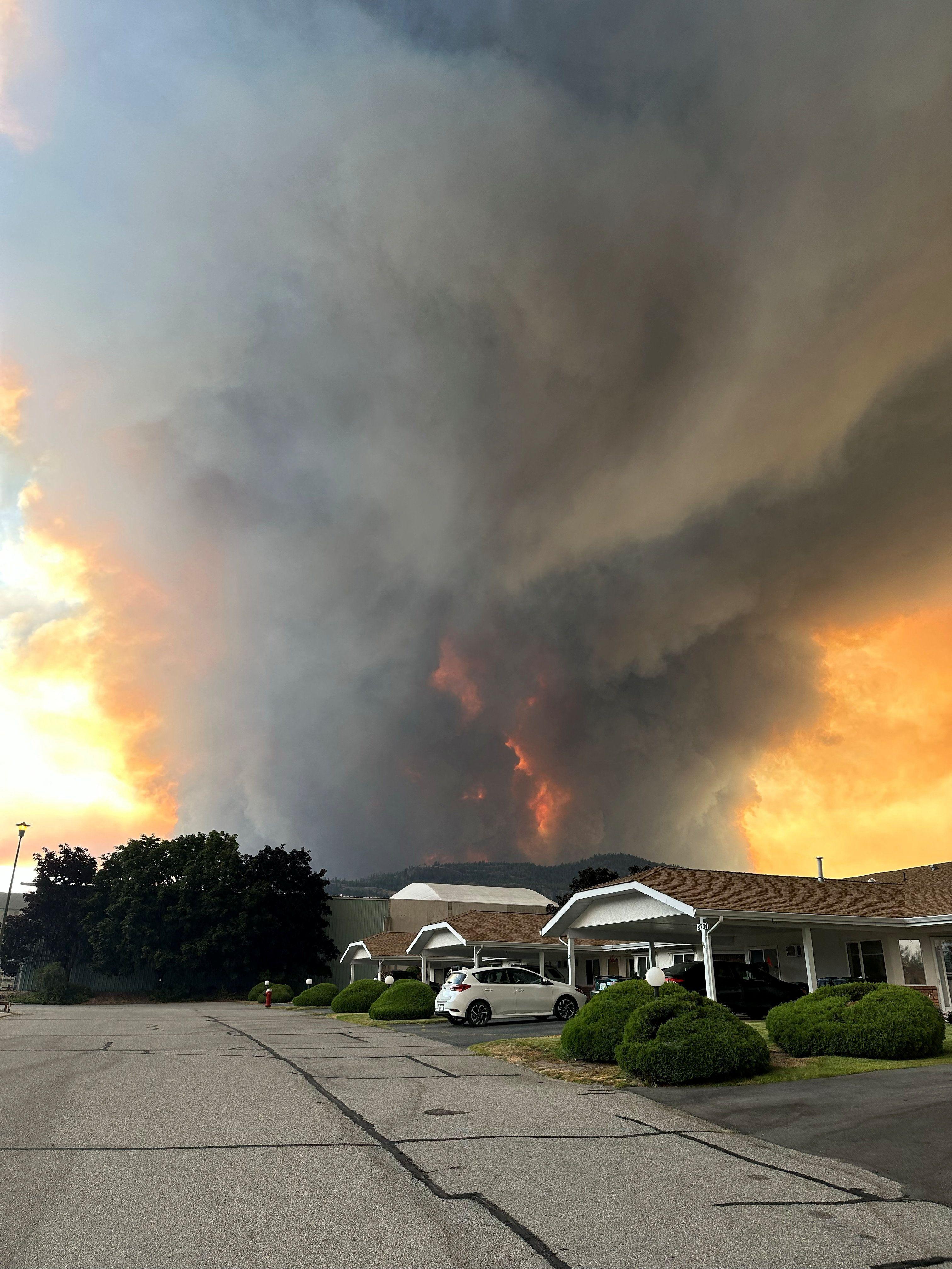 Fast-moving Canada wildfire doubles in size forcing thousands to flee homes