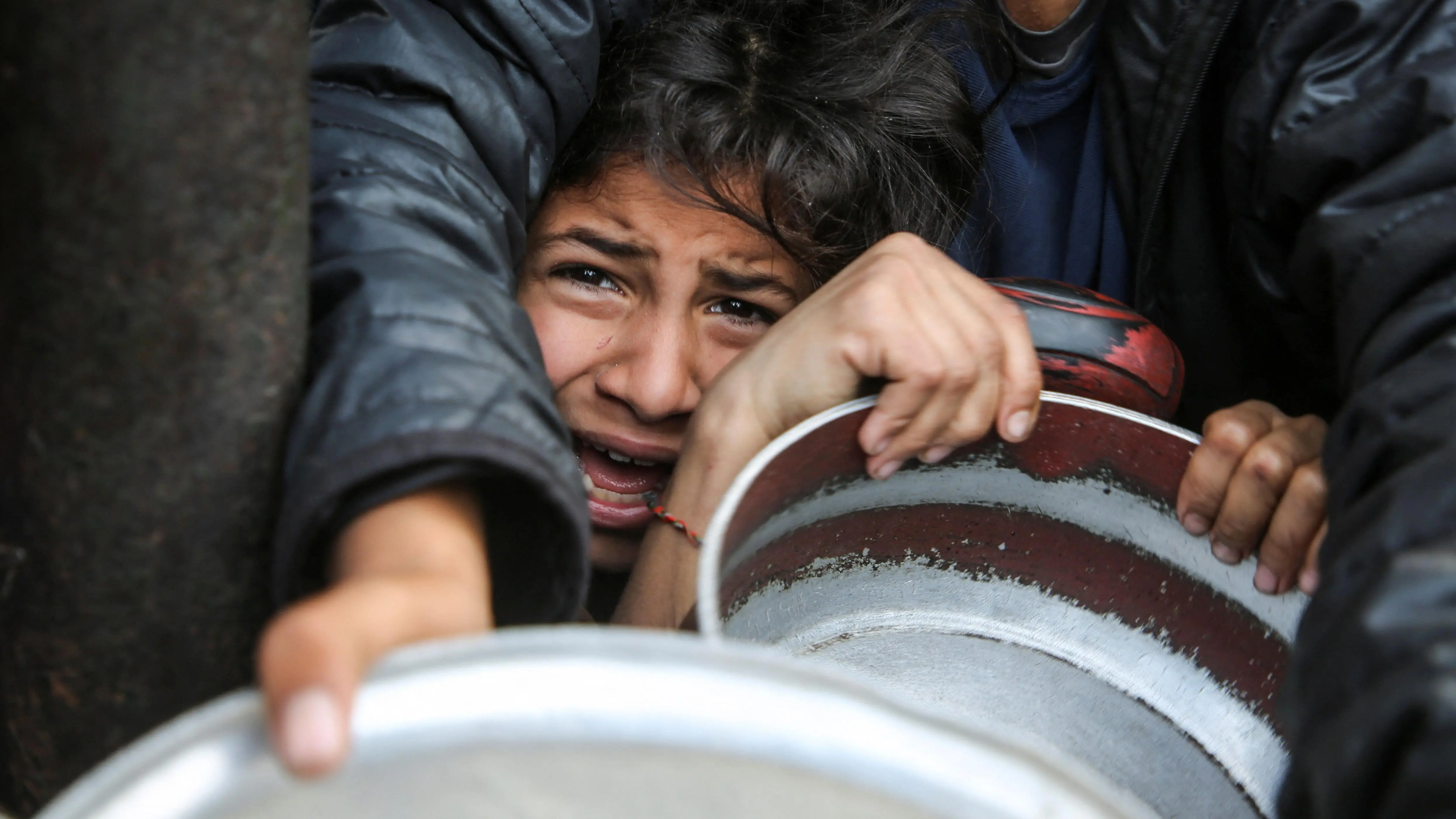 فلسطينيون يتجمعون لتلقي الطعام المطهو في مطبخ خيري في خان يونس جنوب قطاع غزة
