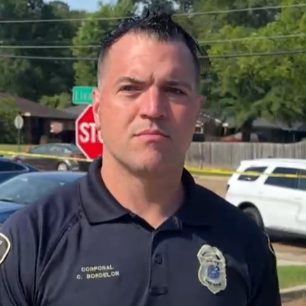 El cabo Chris Bordelon, de la policía de Shreveport, con una camisa azul oscura que incluye su nombre y rango y el escudo de la policía