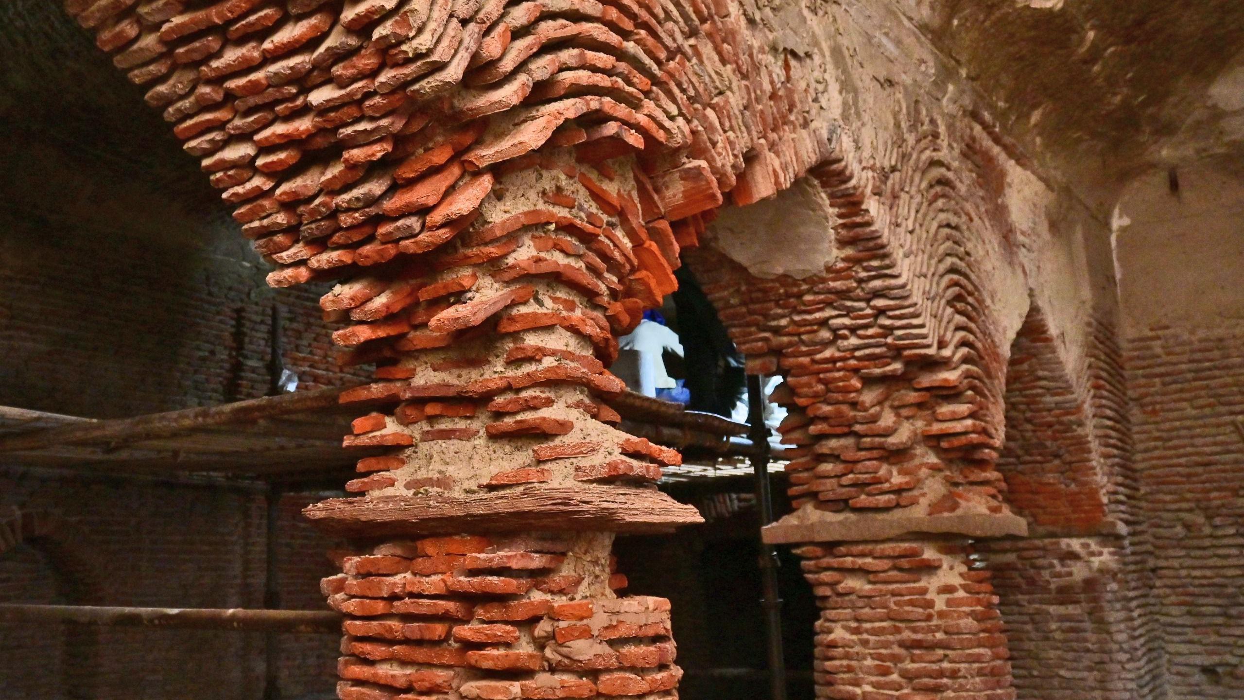 The dilapidated structure of the Shahi Bawarchikhana inside Chota Imambara before conservation work began, with exposed lakhauri brick walls visible.