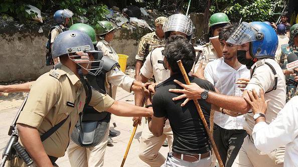 Police personnel detains youths and students during a 'Bihar Bandh' protest demanding the resignation of Union Education Minister Dharmendra Pradhan over alleged irregularities in the NEET examination, at Dak Bungalow crossing on July 25, 2026 in Patna, India. 