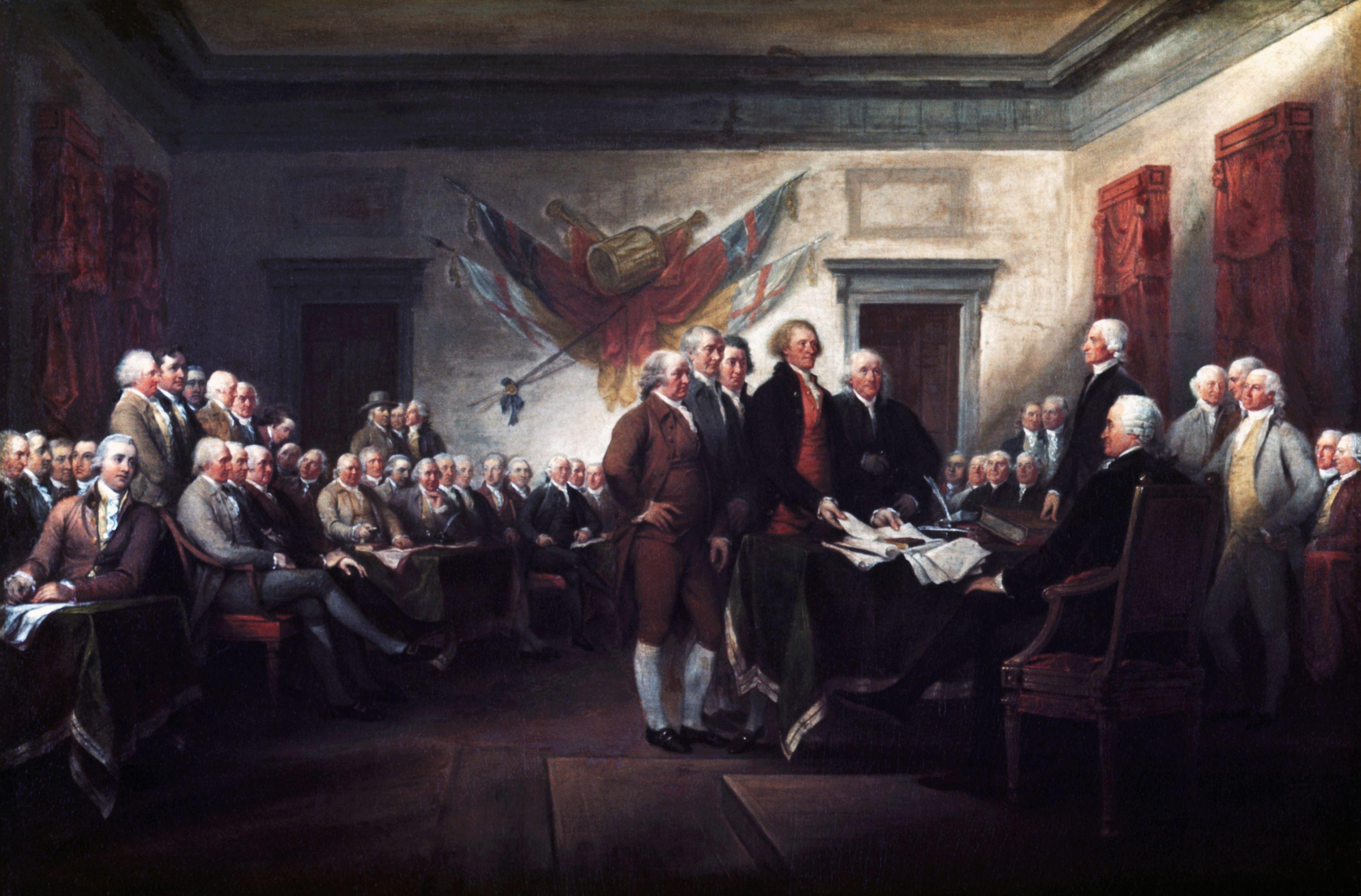 Pintura histórica de una asamblea de representantes reunidos en un salón mientras se presenta un documento oficial.