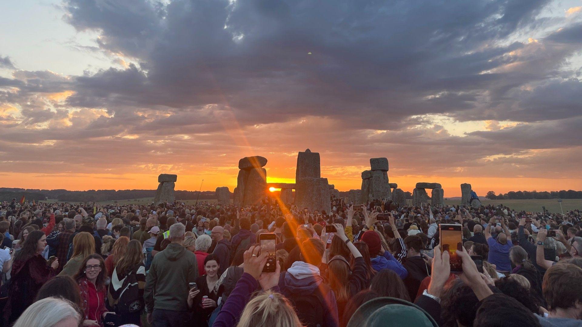 Summer solstice celebrations under way as parts of UK faces 34C heat on longest day of year 