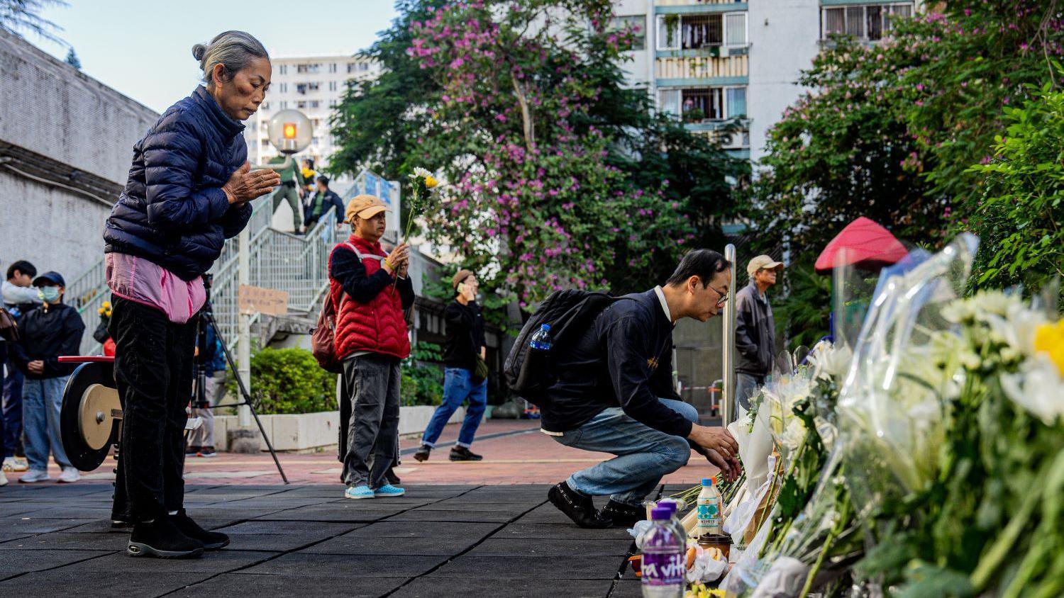 2025年11月29日，人們在香港大埔區宏福苑住宅外敬獻鮮花，悼念火災罹難者。