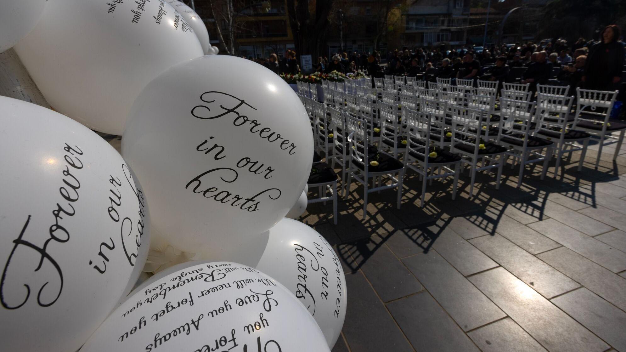 'Zauvek u našim srcima' jedna od poruka na belom balonu, u daljini 63 stolice