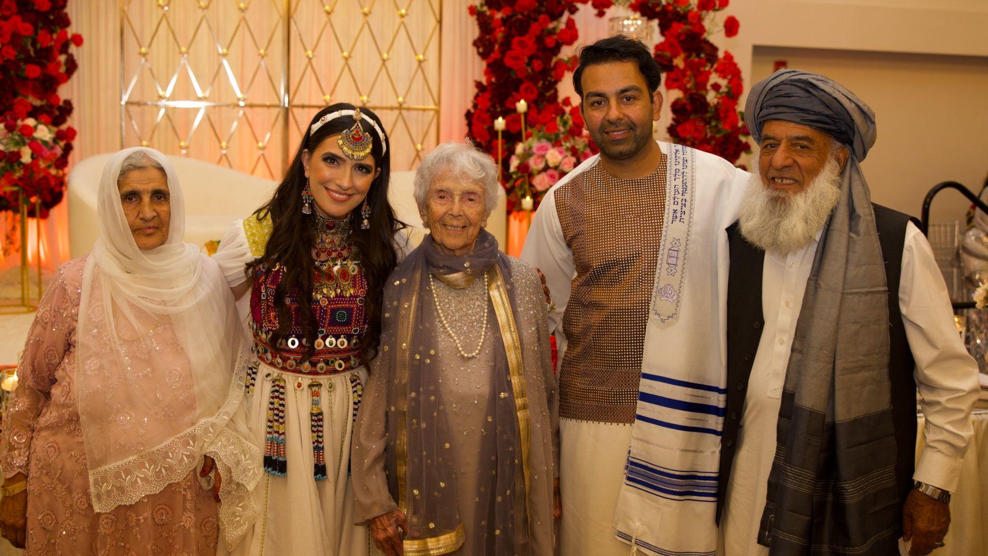 Sammi and Safi standing alongside their family members at their wedding.