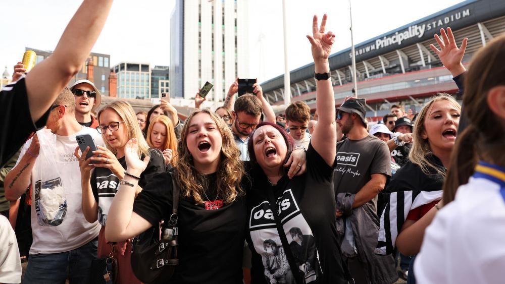Rock and roll is back, Oasis fan says as doors open for comeback gig