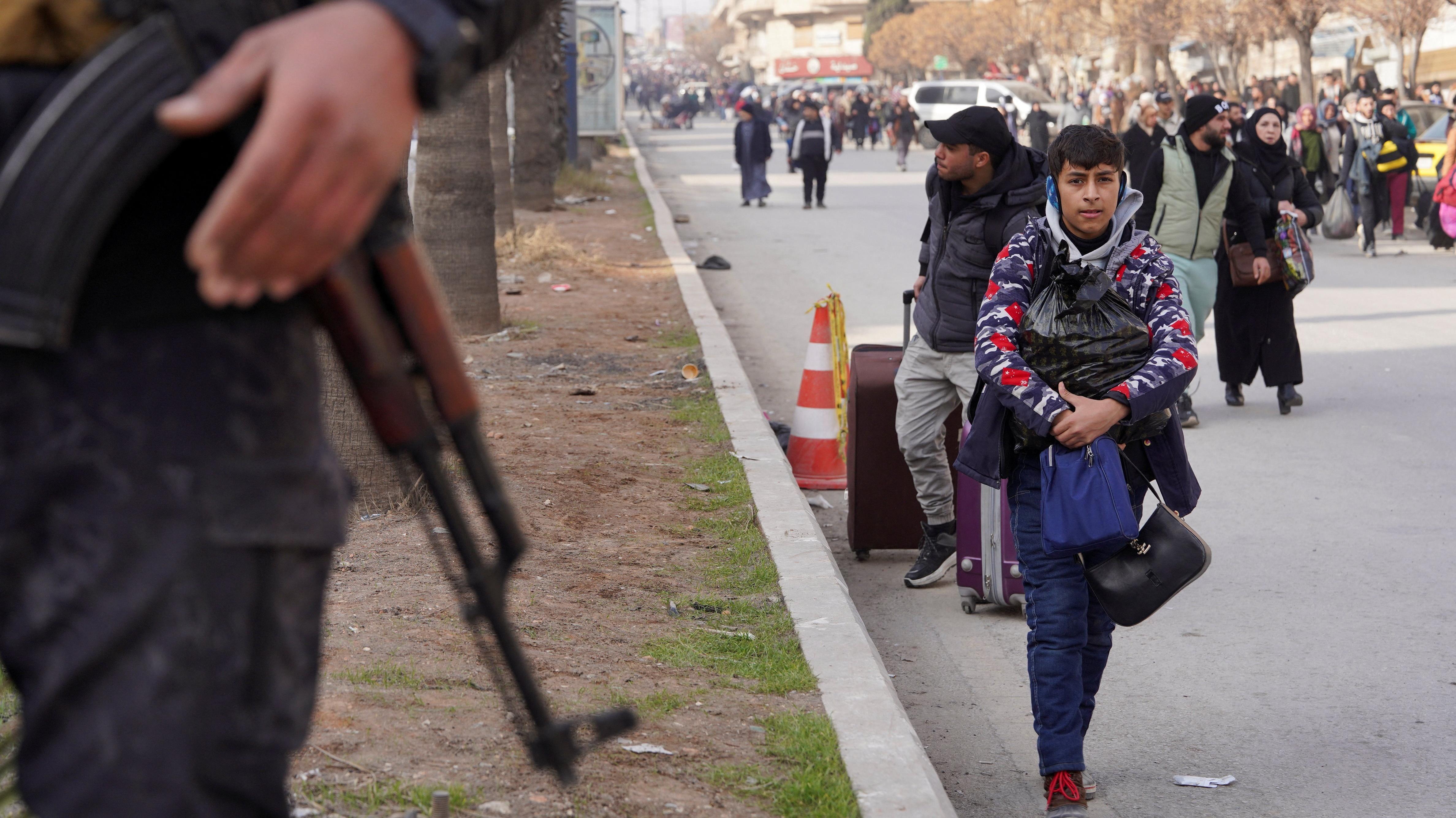 مجموعة من المدنيين يحملون حقائبهم وأمتعتهم أثناء فرارهم عقب تجدد الاشتباكات بين الجيش السوري وقوات سوريا الديمقراطية، في حلب، سوريا، 7 يناير/كانون الثاني 2026. رويترز/كرم المصري.