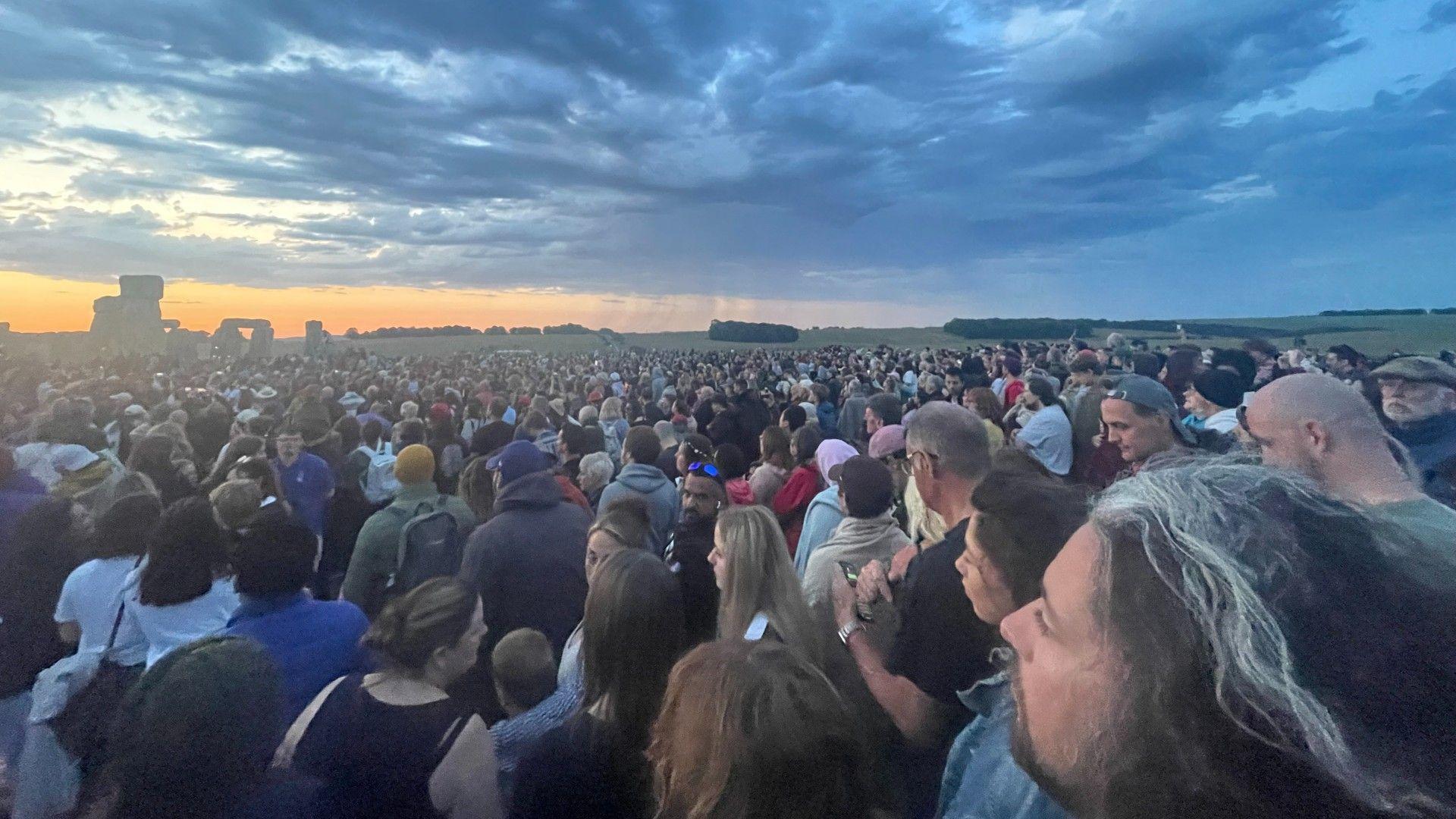 Summer solstice celebrations under way as parts of UK faces 34C heat on longest day of year 
