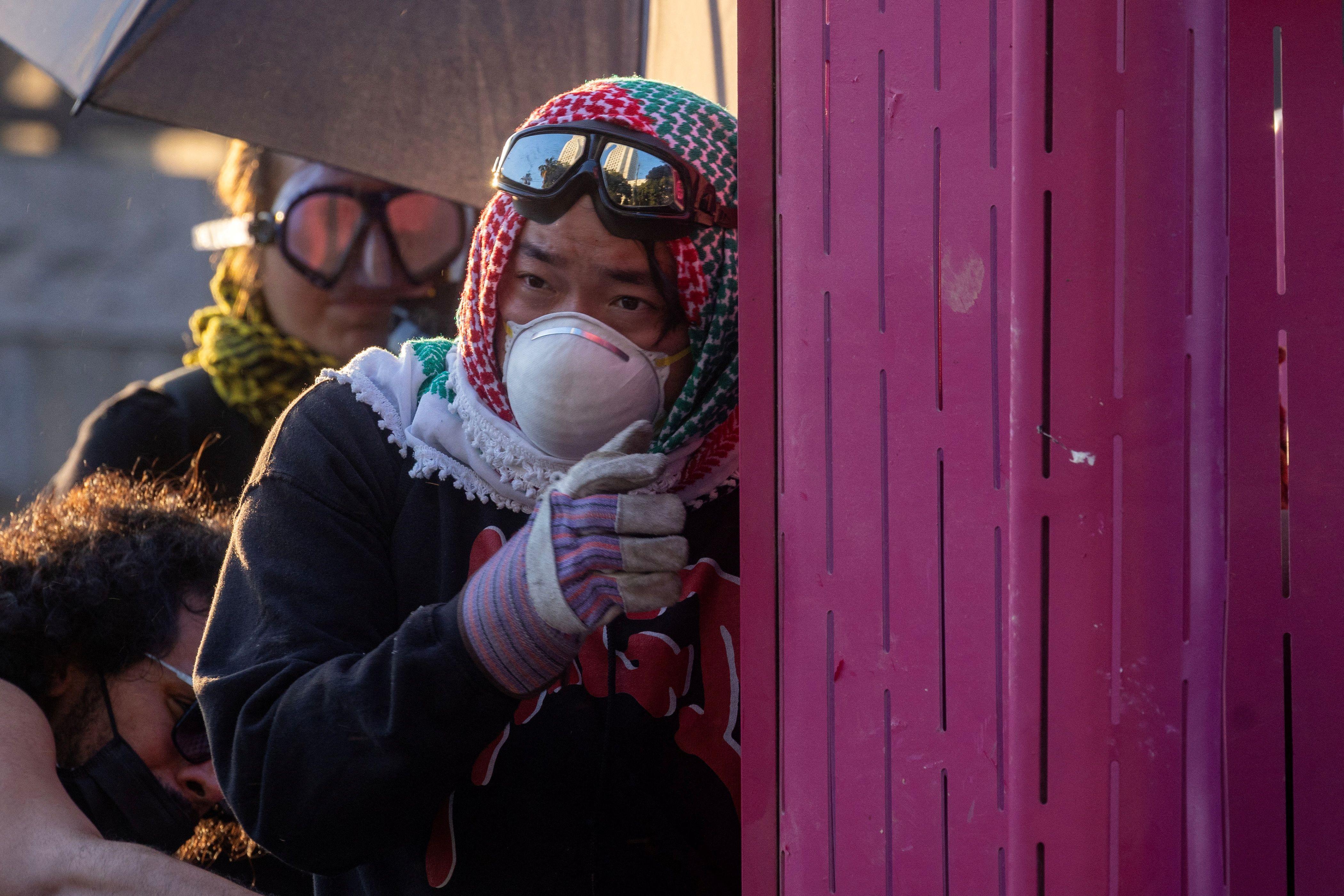 Los Anđeles kao ratna zona: Guverner Kalifornije najavio tužbu protiv Trampove administracije 1 Muškarac sa zaštitnom maskom umotan u maramu na ulici