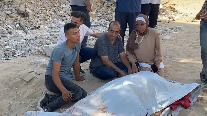 صورة لفلسطينيين حول جثة في غزة