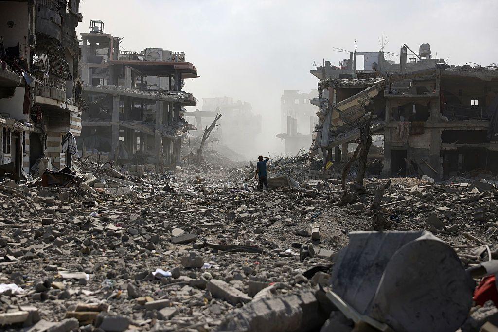شاب فلسطيني يقف في شارع مليء بالأنقاض إثر انفجار في حي الصفطاوي، غرب جباليا شمال قطاع غزة.