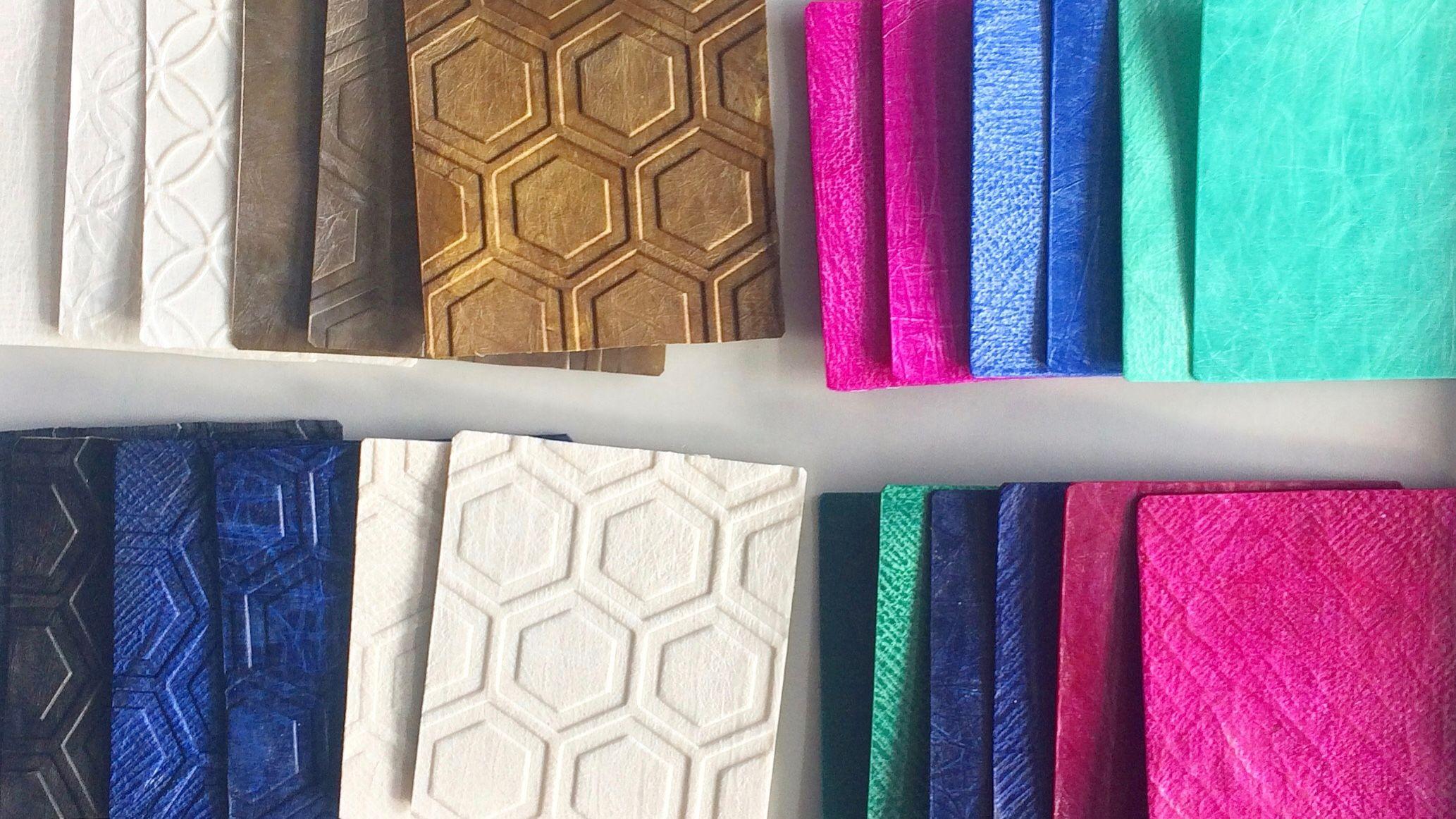 各種鮮豔色彩與圖案質地的類皮革材料樣本，整齊擺放以供展示