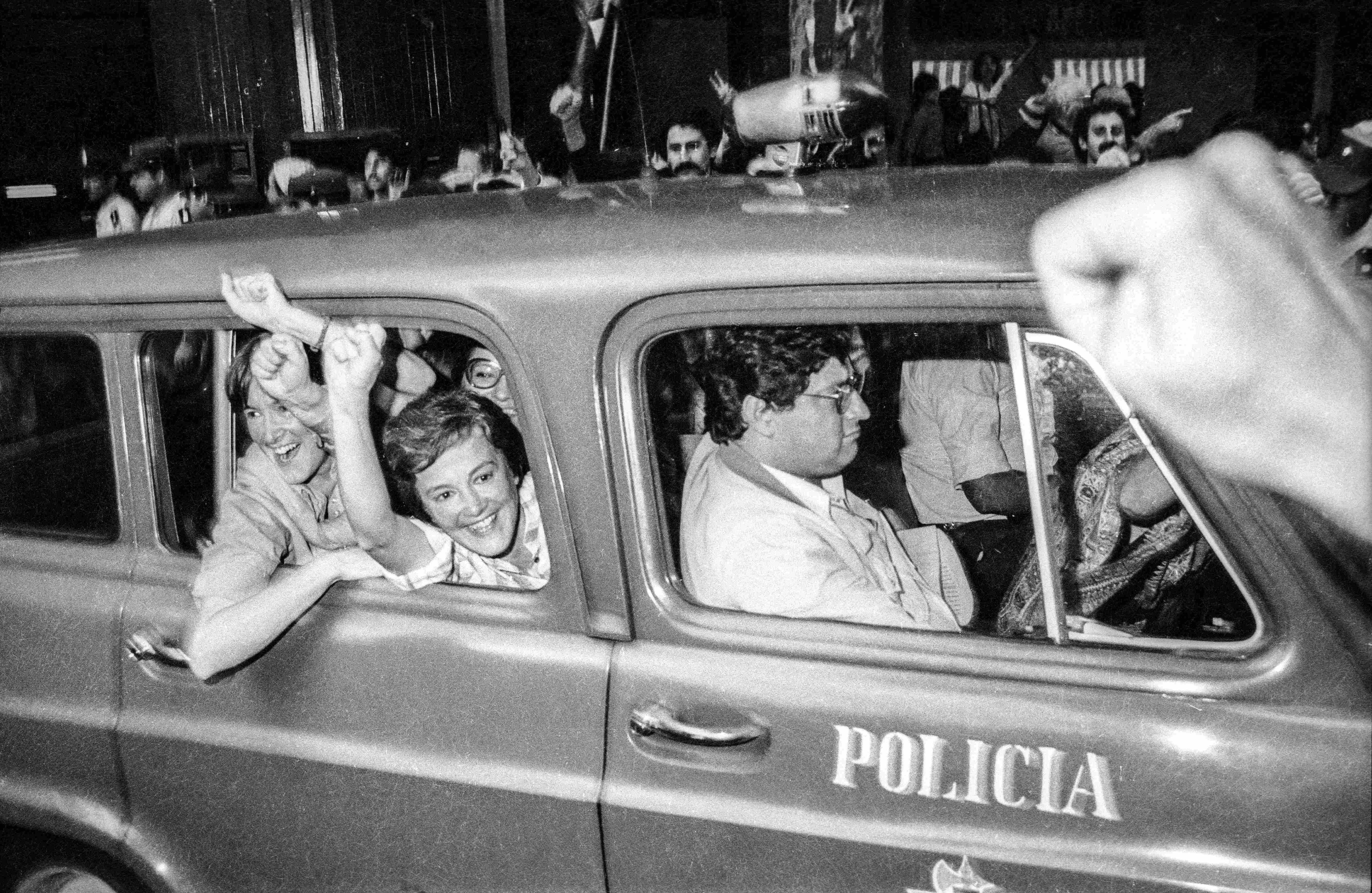 Lucía Topolansky y su hermana María Elia muestran el puño apretado desde una camioneta de la policía el día de 1985 en que fueron liberadas por una ley de amnistía.