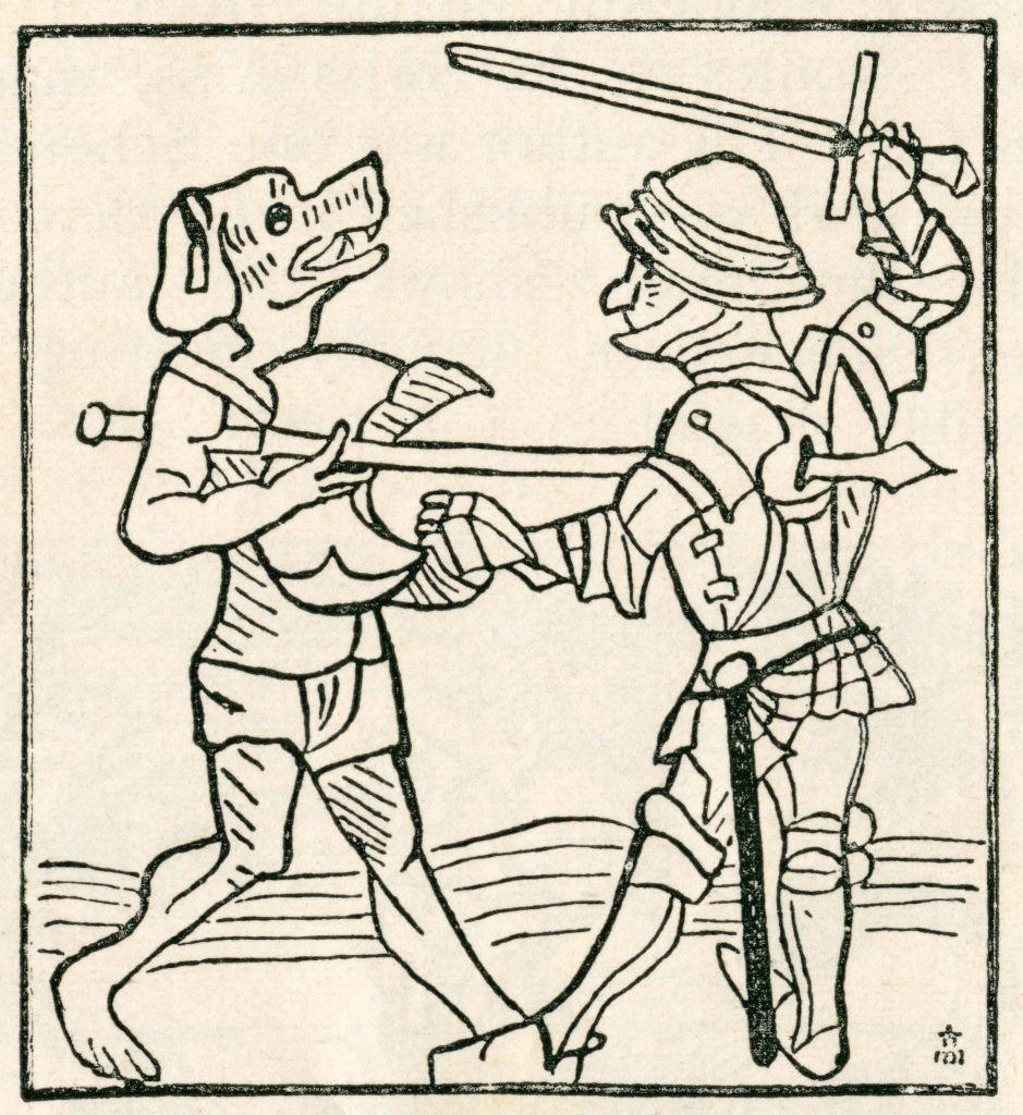 Gravura medieval retrata um guerreiro enfrentando um cinoc&eacute;falo, criatura mitol&oacute;gica com corpo humano e cabe&ccedil;a de c&atilde;o que figurava em relatos de viajantes e lendas da &eacute;poca.
