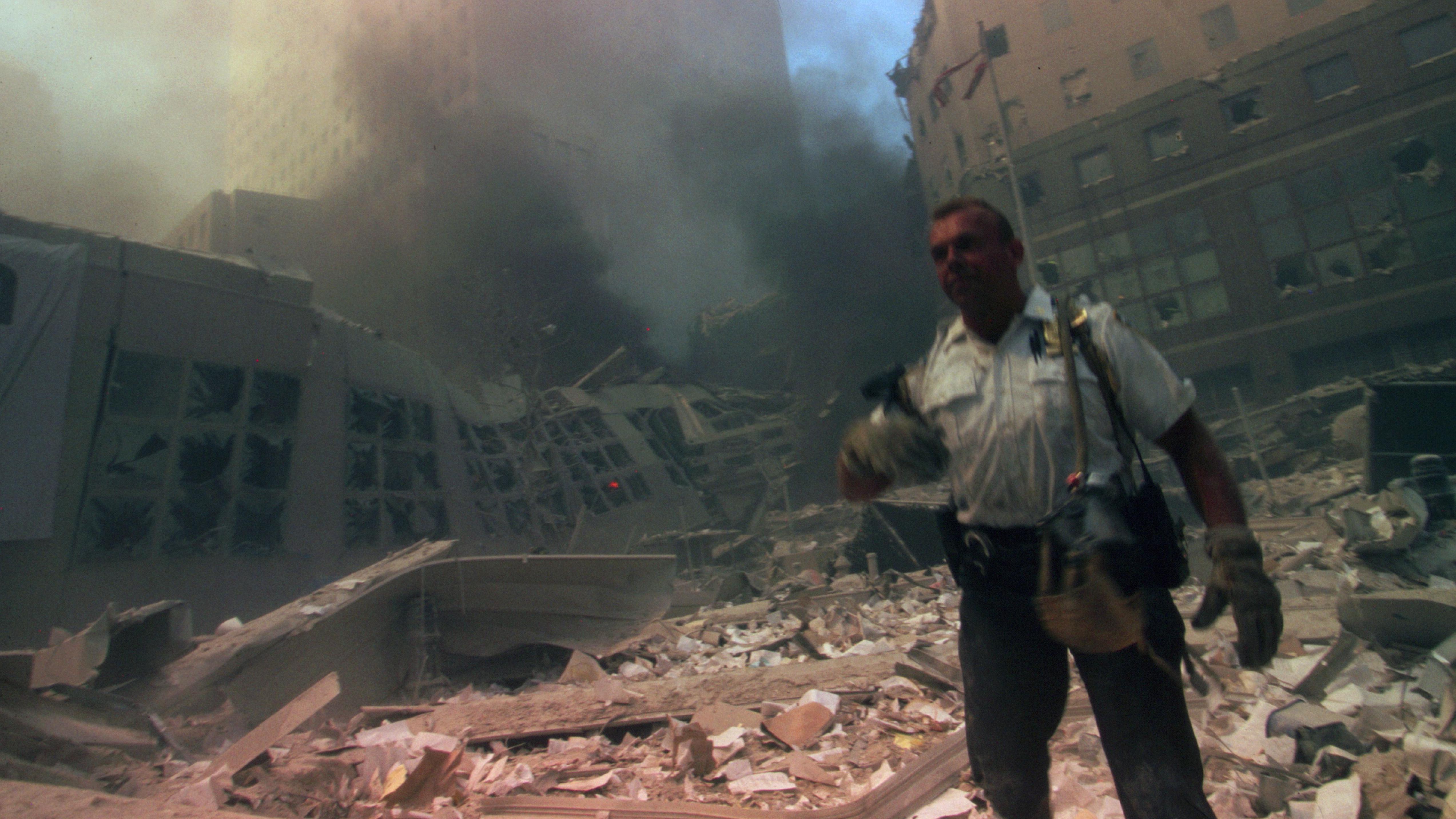 A rescuer worker amid the rubble of New York's World Trade Center following the attacks on 11 September 2001, in which two planes were flown into the city's Twin Towers, destroying the iconic buildings - the official death toll for the plot that day throughout the US is 2,977 plus 19 attackers