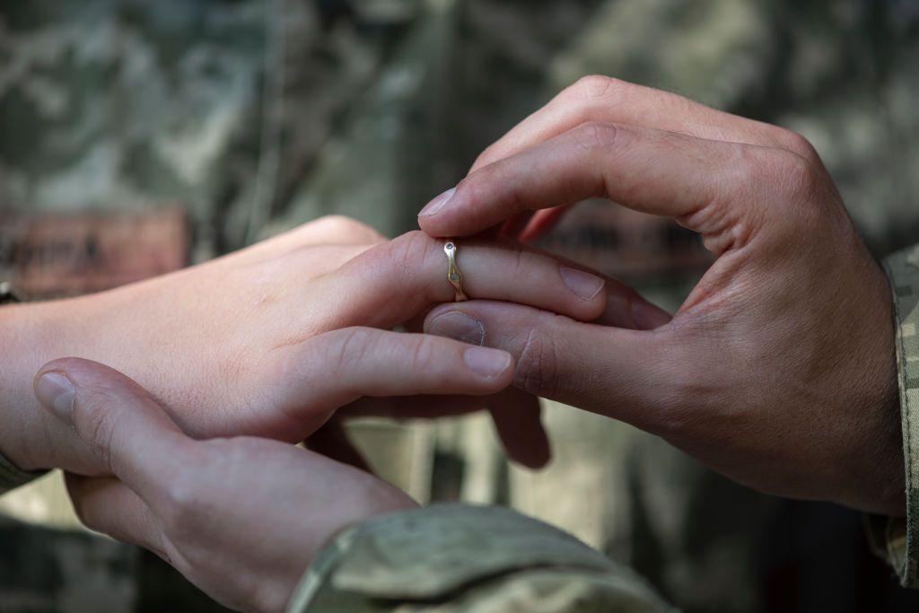un hombre le pone un anillo de bodas a una mujer