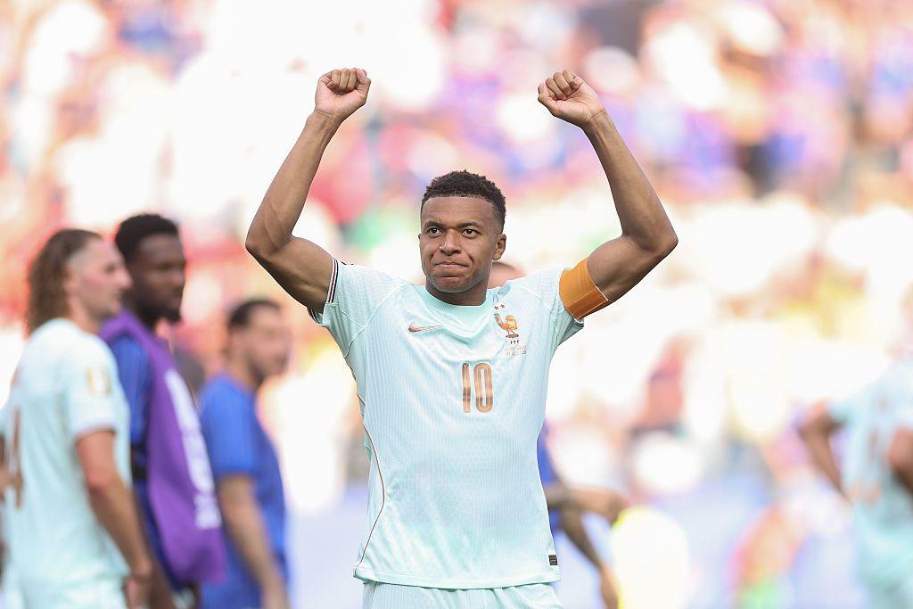 Kylian Mbappé celebra una jugada levantando los brazos.