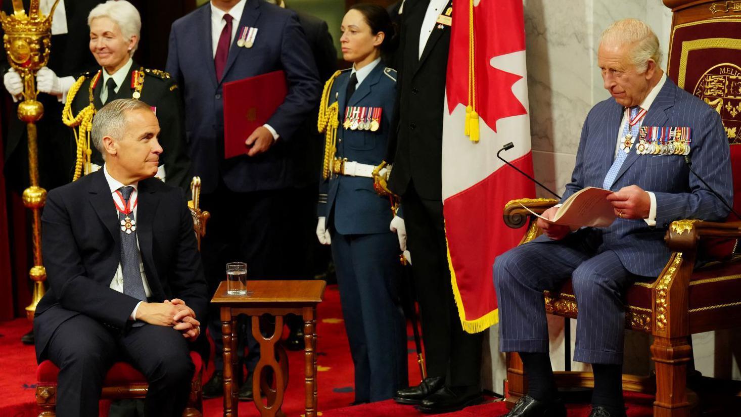 Canada's Prime Minister Mark Carney looks on as Britain's King Charles delivers the speech from the throne in the Senate in Ottawa, Canada, May 27, 2025.