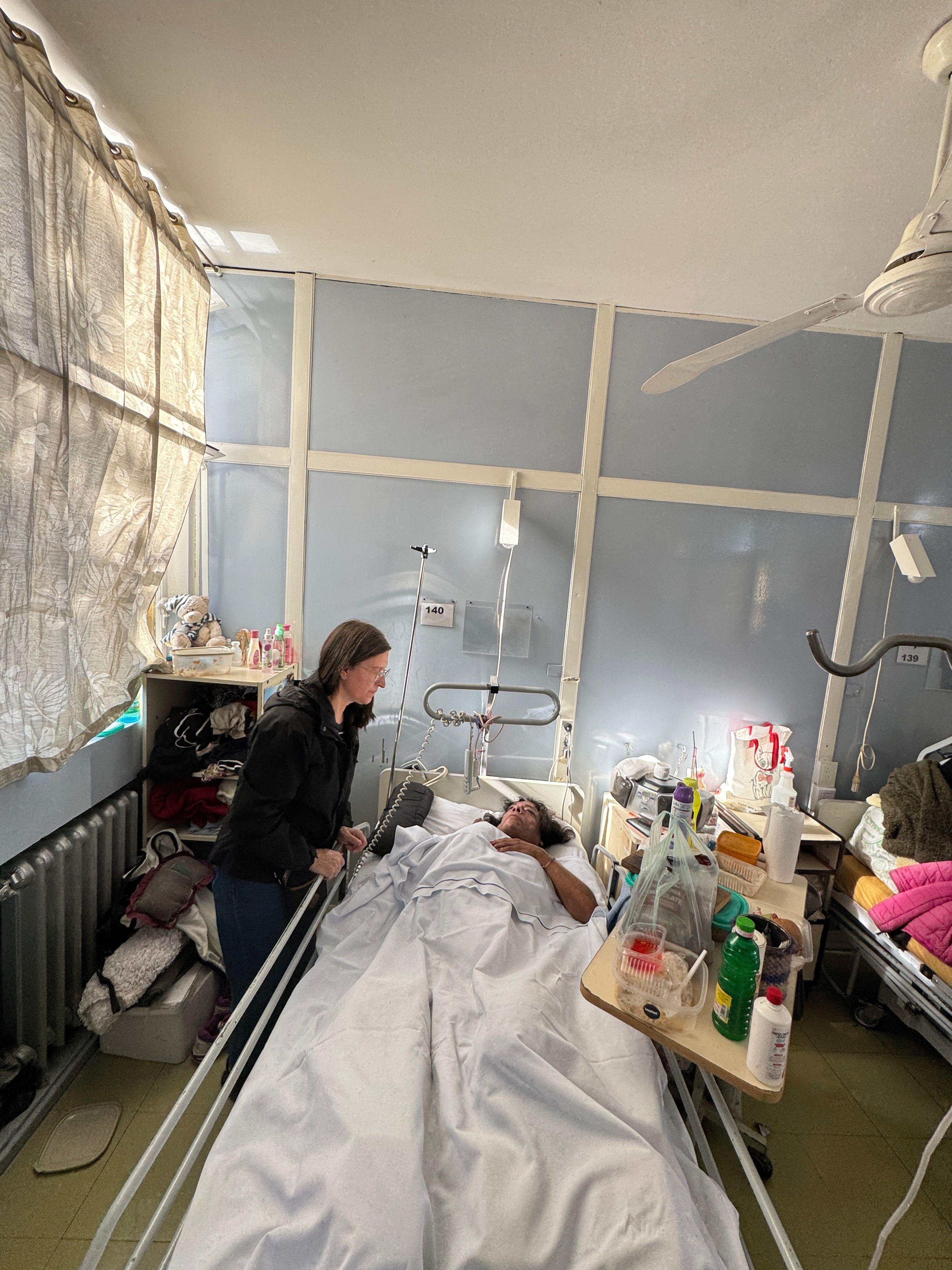 Astorga junto a la cama de una mujer trans que está hospitalizada.