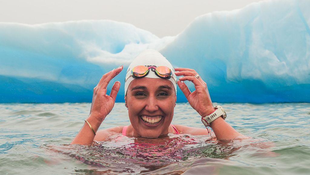 Bárbara Hernández nadando frente a un glaciar antártico.