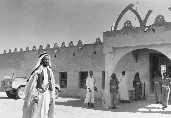 Sheikh Shakhbut bin Sultan Al Nahyan, ruler of the Emirate of Abu Dhabi, outside his oasis palace at July 1961.