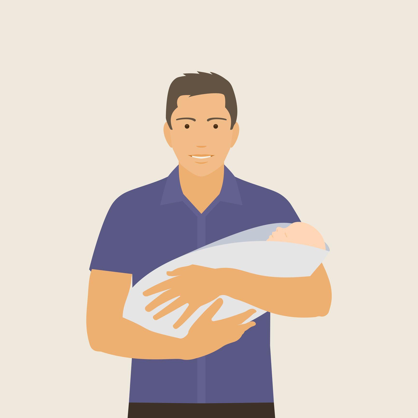 أب يحمل طفله حديث الولادة.