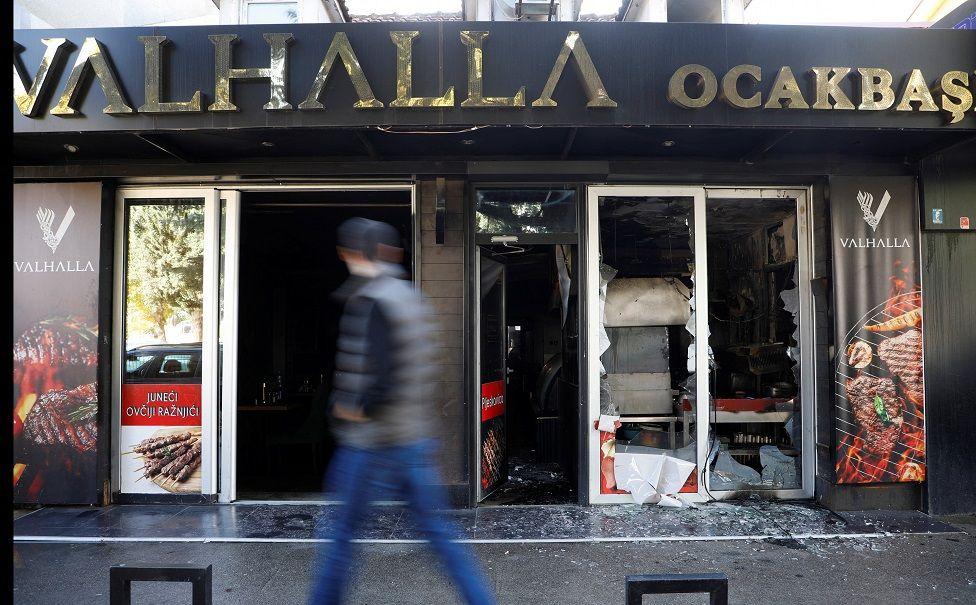 Protesti u Crnoj Gori 'rasistički': ombudsman, nastavljena privođenja 1 Čovek gleda u prolazu zapaljenu radnju turskog državljanina u Podgorici