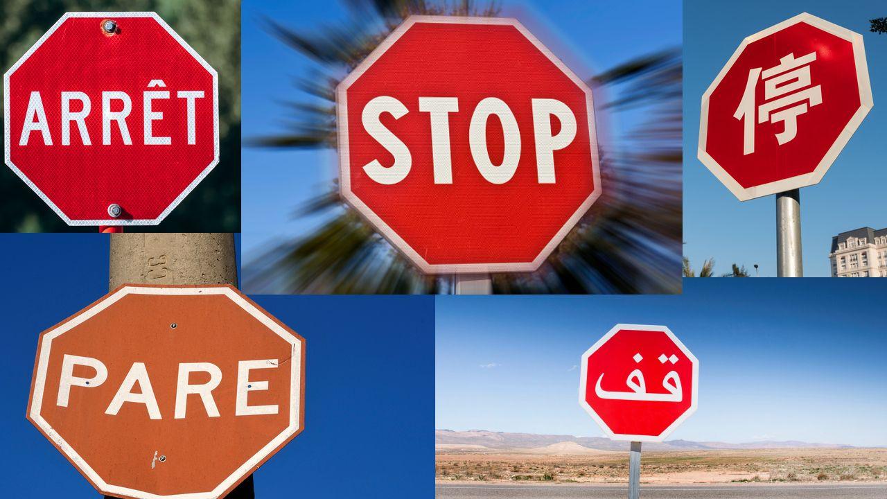 Señales de PARE en varios idiomas, todos iguales: un octágono rojo con letras y bordes en blanco