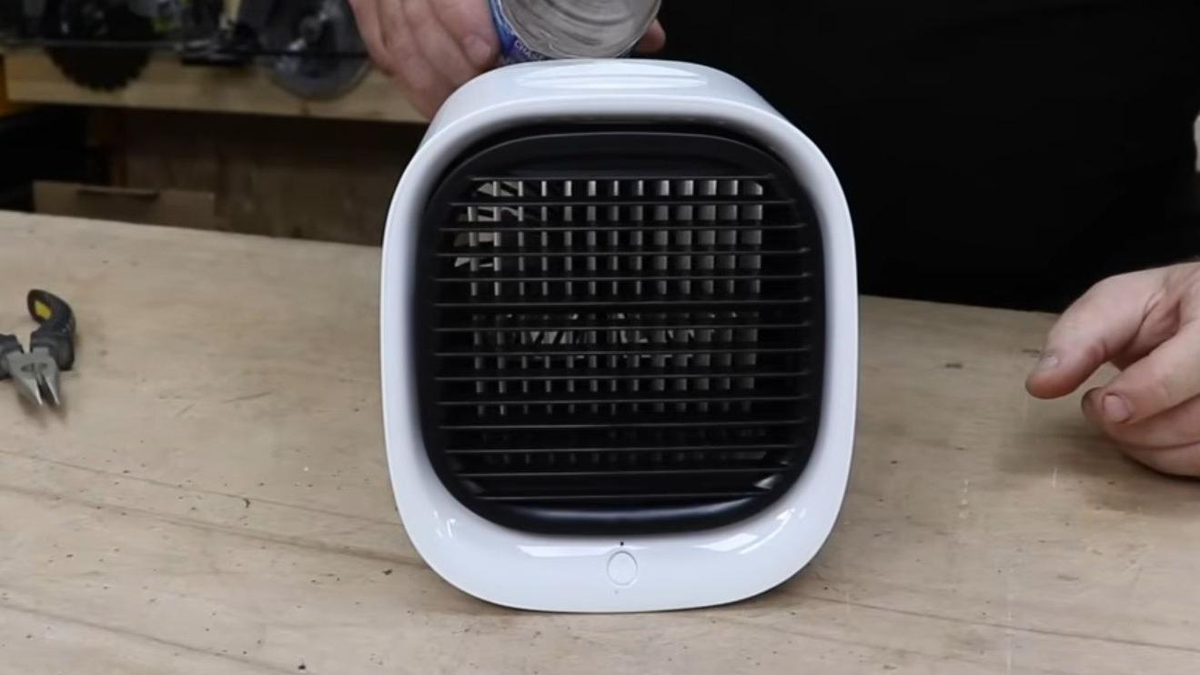 A white portable air conditioner on a desk