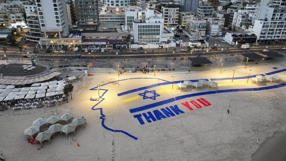 A giant sign created on a Tel Aviv beach reads