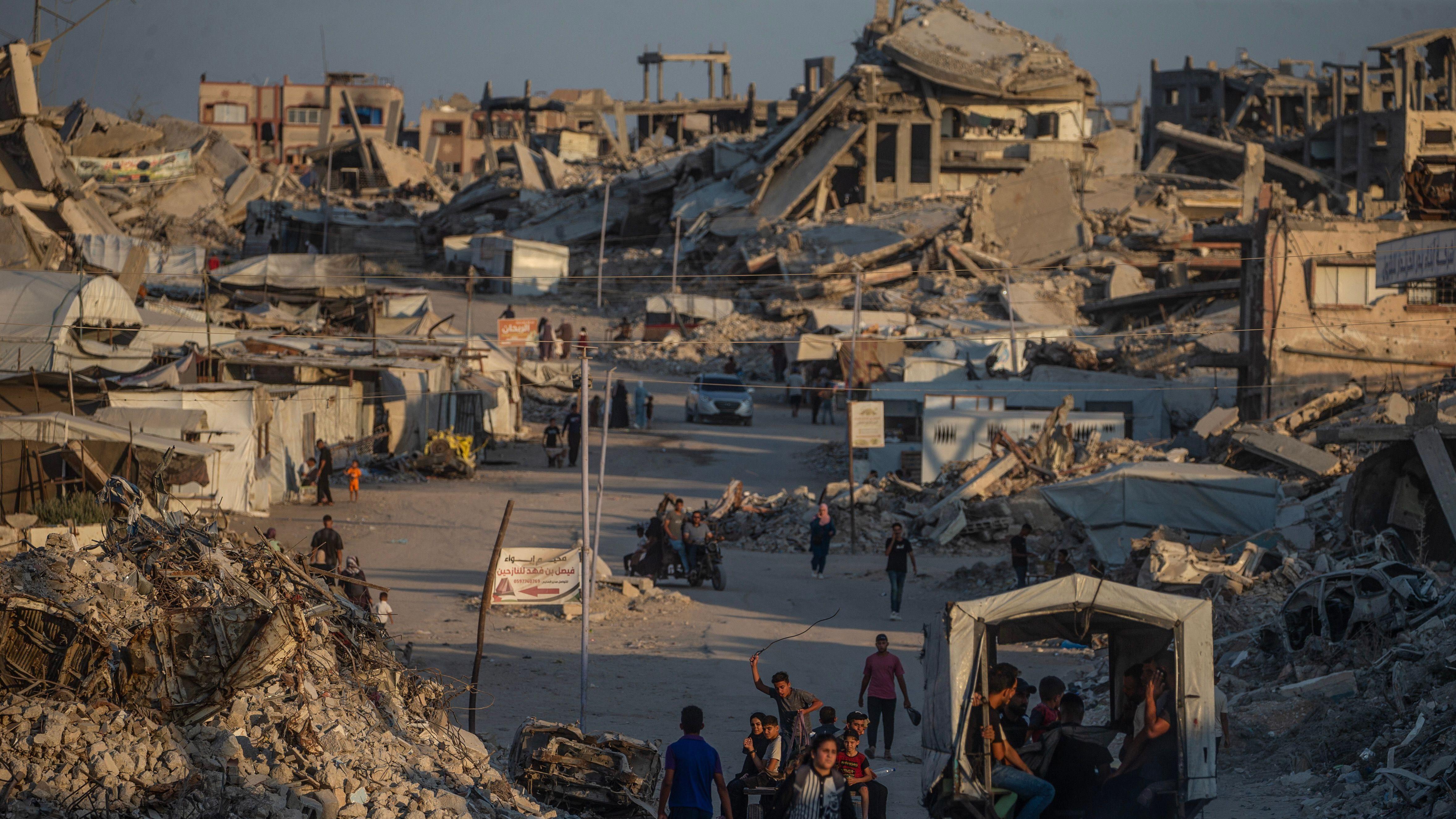 Palestinos desplazados caminan entre casas destruidas en Jabaliya, norte de la ciudad de Gaza, 7 de agosto de 2026