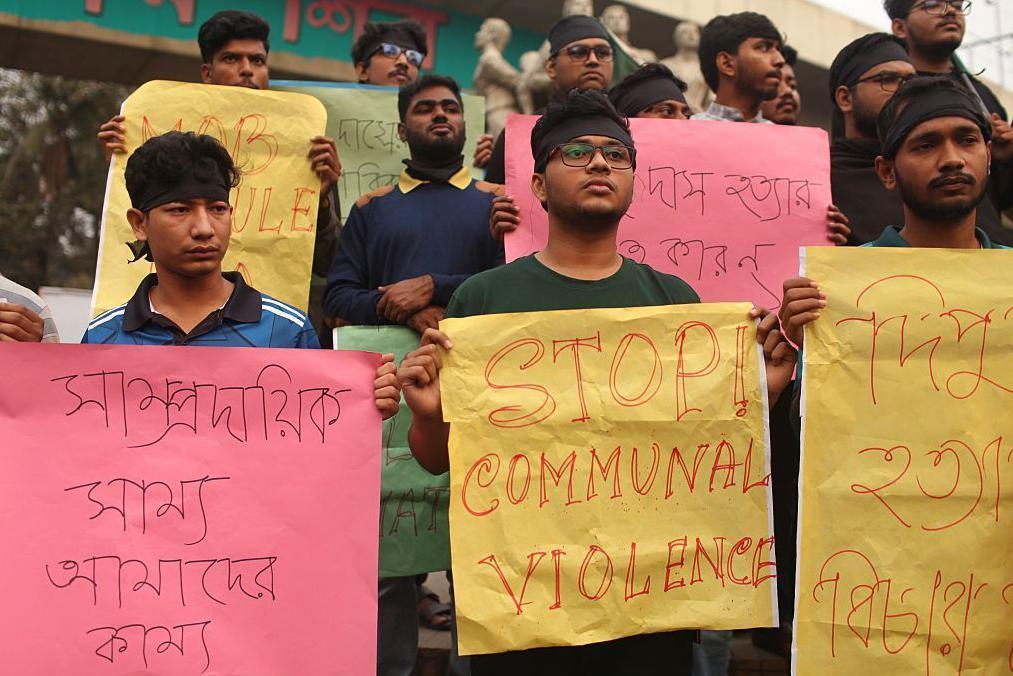 Students of Dhaka University take part in a protest march in the Dhaka University area of Dhaka, Bangladesh, on December 21, 2025, demanding justice over alleged mob violence, including the killing of Dipu Chandra Das following false blasphemy accusations and the death of seven-year-old Ayesha in an arson attack on a BNP worker's house. (Photo by MD Abu Sufian Jewel/NurPhoto via Getty Images)