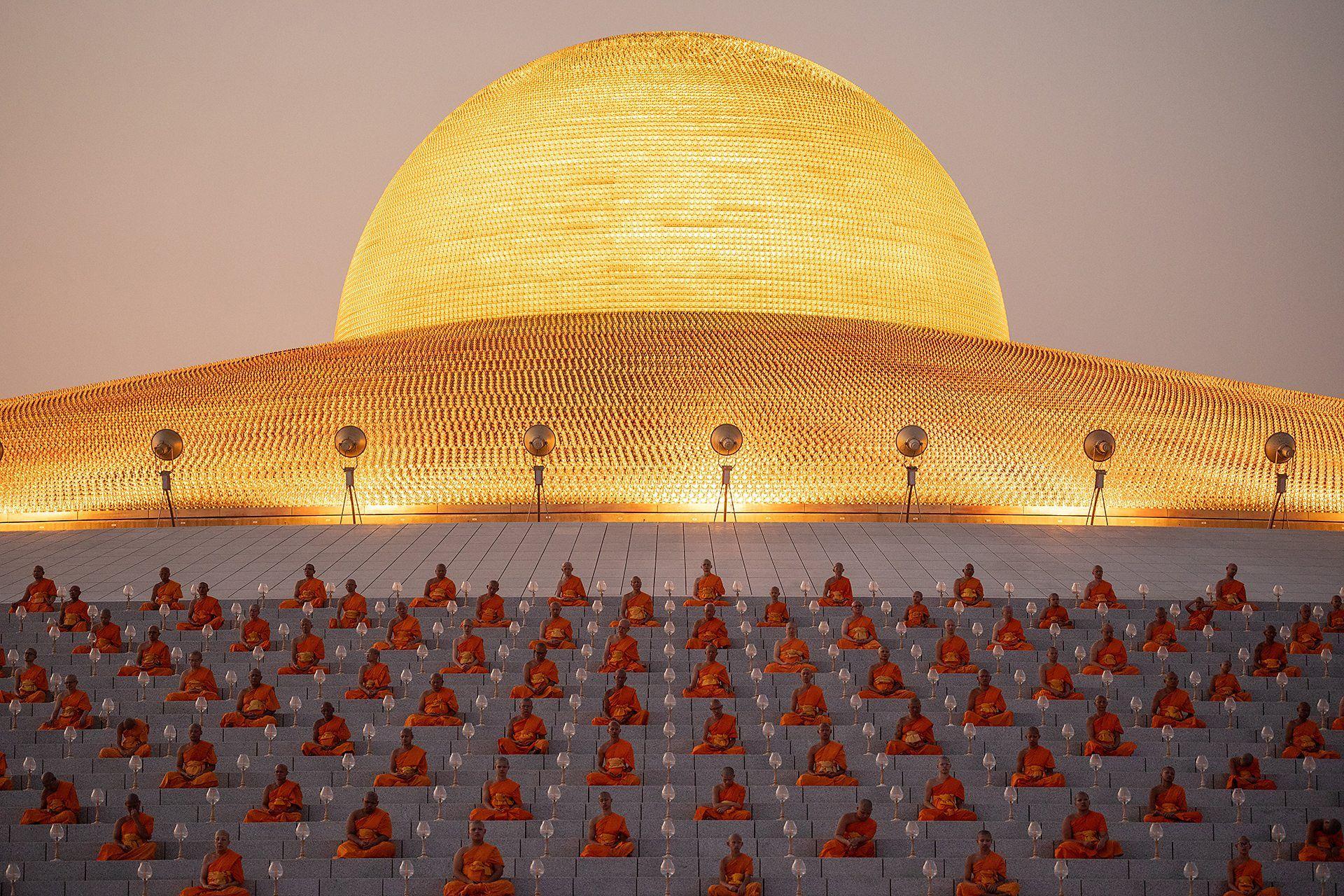 Imagen panoramica donde se ve a un grupo de monjes rezando.