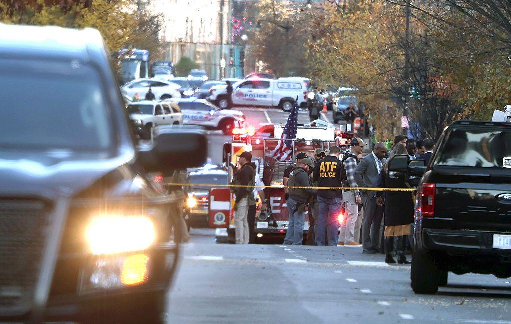US law enforcement officers gathered near the scene of a shooting in Washington DC. 