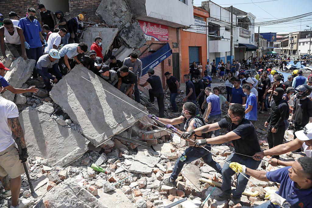 Rescatistas y vecinos  trabajan en las ruinas de un edificio derrumbado en Cali.