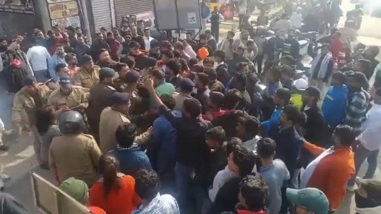 Protesters and police outside Deepak Kumar's gym in India's Kotdwar town