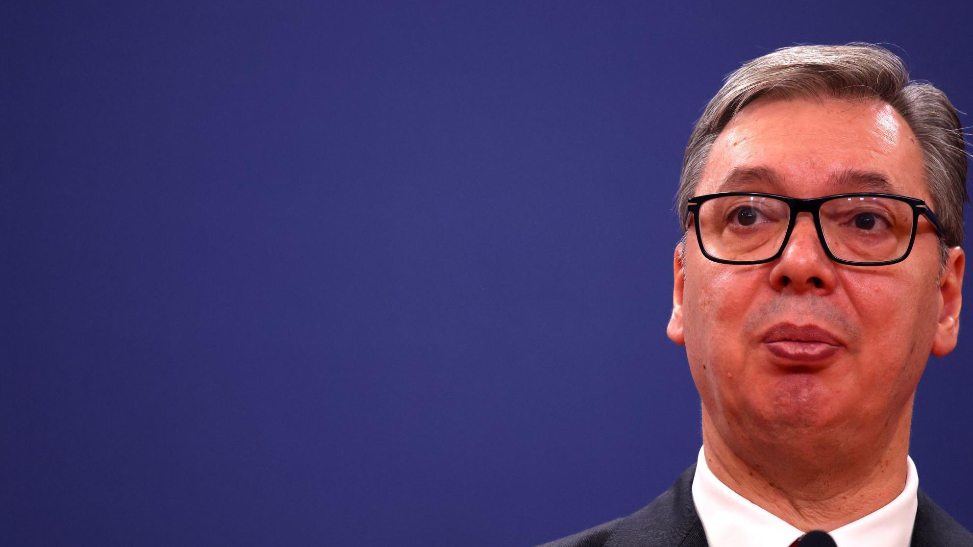 Odluka o NIS-u za sedam dana, bez dotoka nafte do 13. februara Srbija u kolapsu, kaže Vučić 1 Predsednik Srbije sa naočalama i u odelu gleda u daljinu, iza plava pozadina