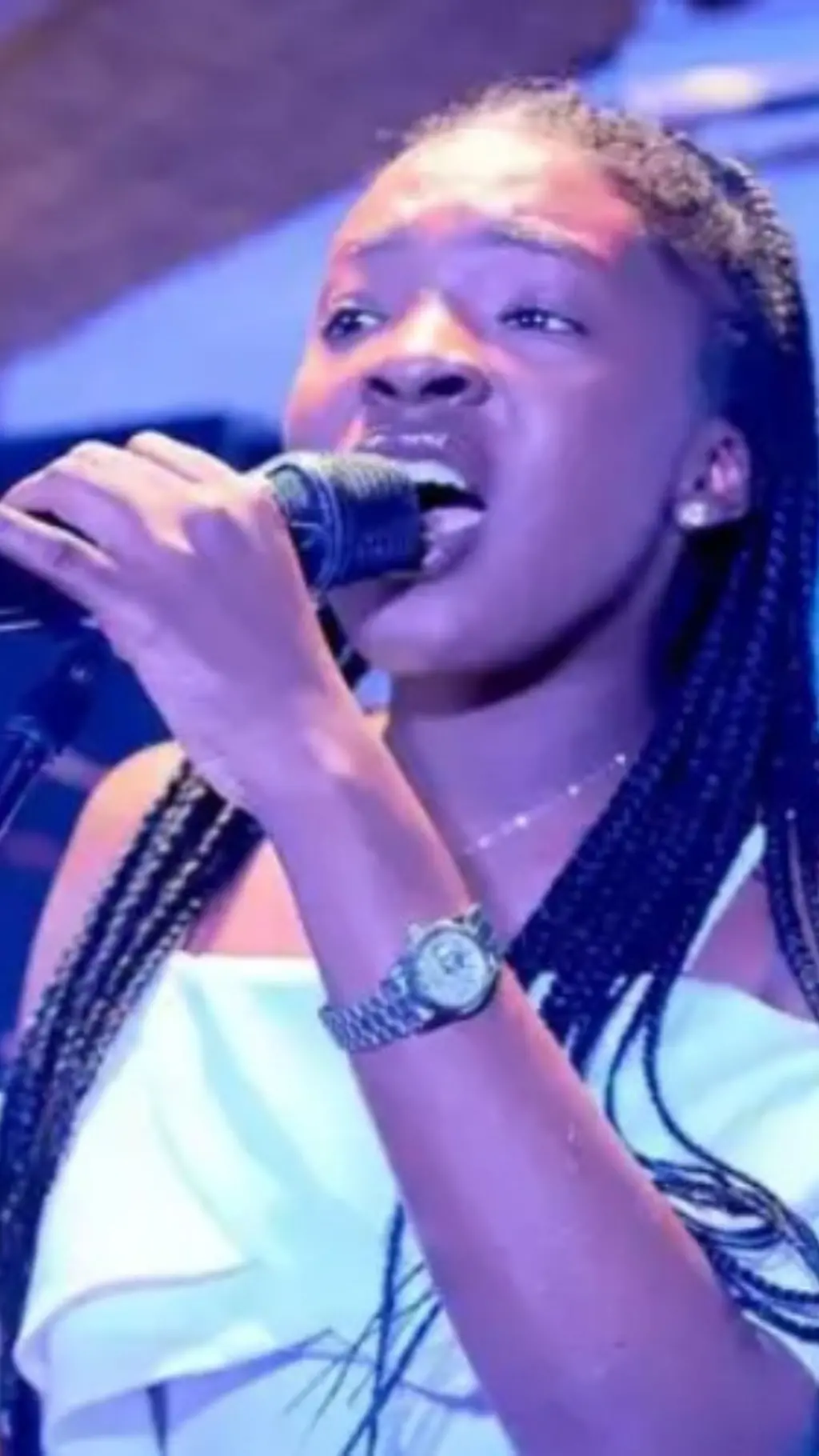 A lady singing with a microphone