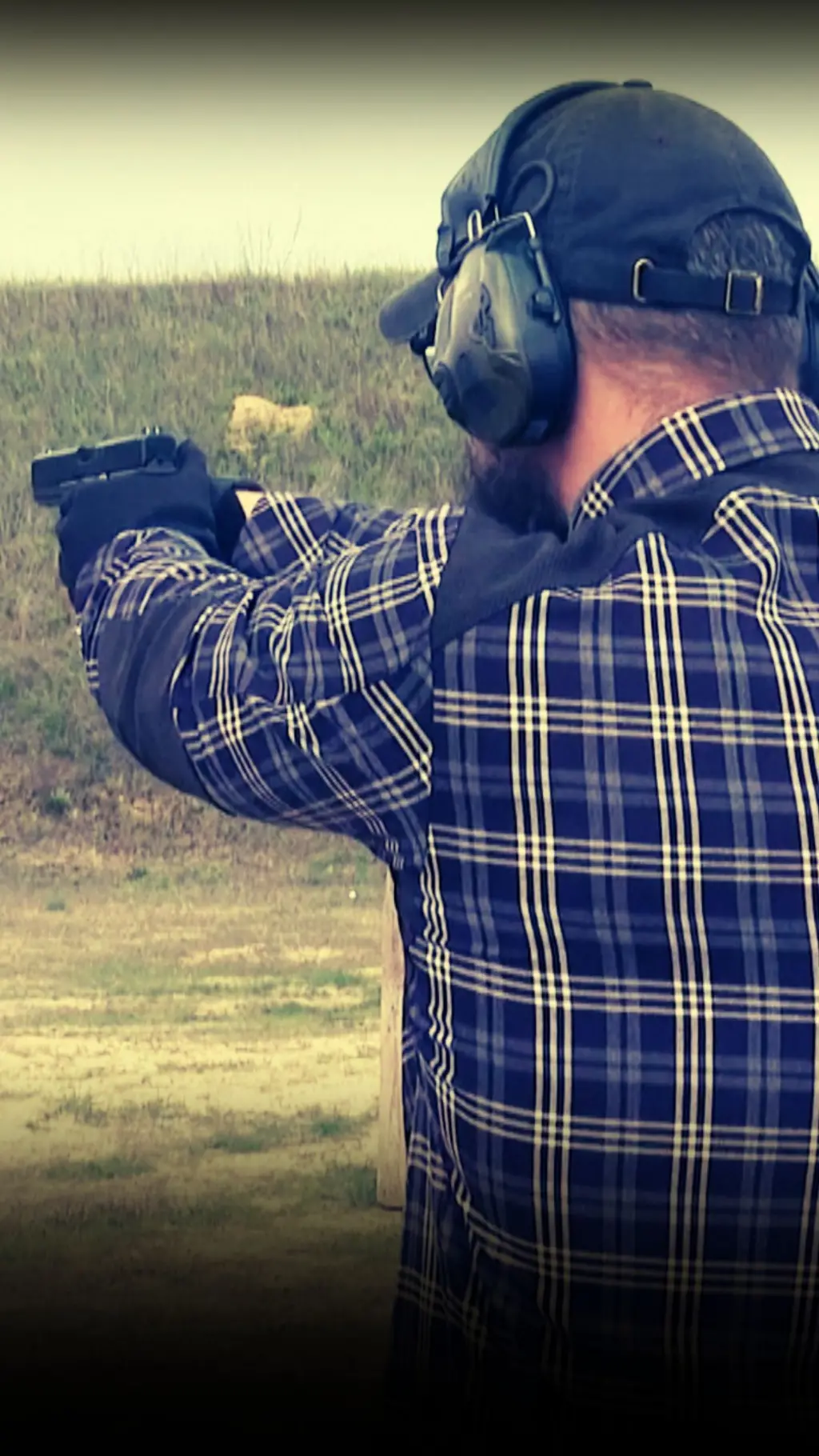 Чоловік у навушниках із пістолетом