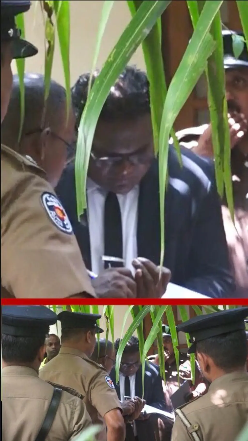 පොලිස් නිලධාරීන් මැද කළු කොට එකක් ගෙන අයෙක් සිටී.