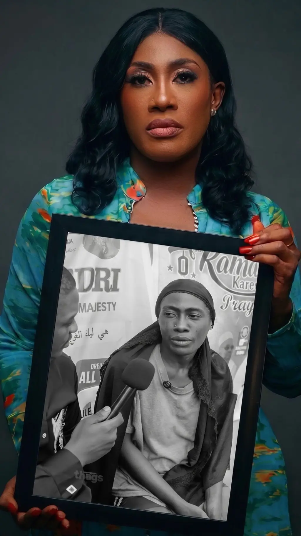 Sarah Etokhana holding a frame of herself showing when she was still addicted to drugs