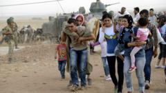 சண்டையிலிருந்து தப்பித்து உயிர்பிழைக்க சிரியாவின் குர்த் இனத்தார் முயலுகின்றனர்