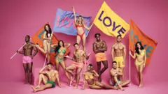 The 2022 Love Island contestants holding flags that read Love. The new series started on ITV on 6 June
