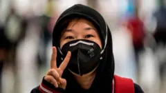 Woman wey wear mask