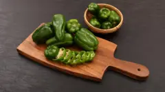 Bell or green peppers on top cutting board