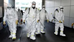 Workers disinfecting a street